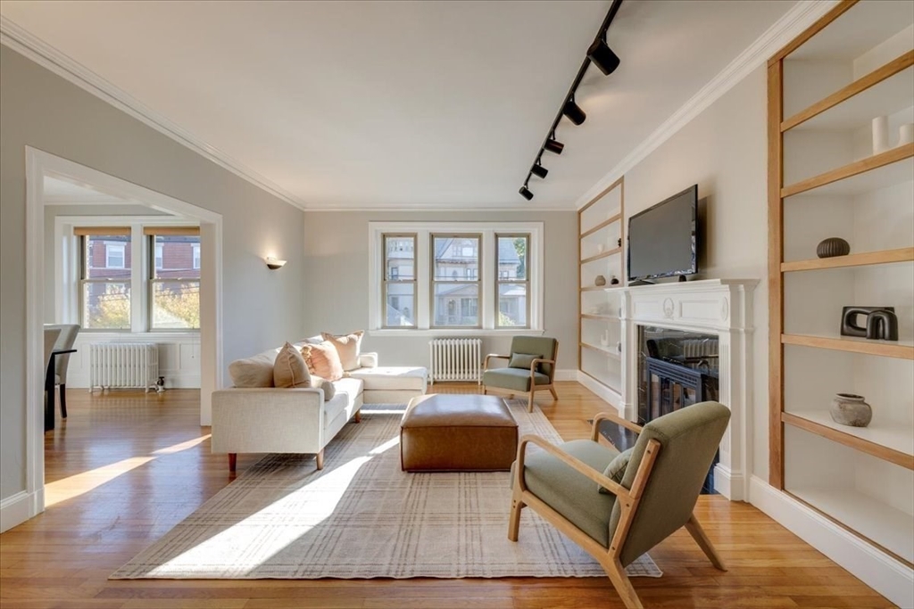 a living room with furniture fireplace and a flat screen tv