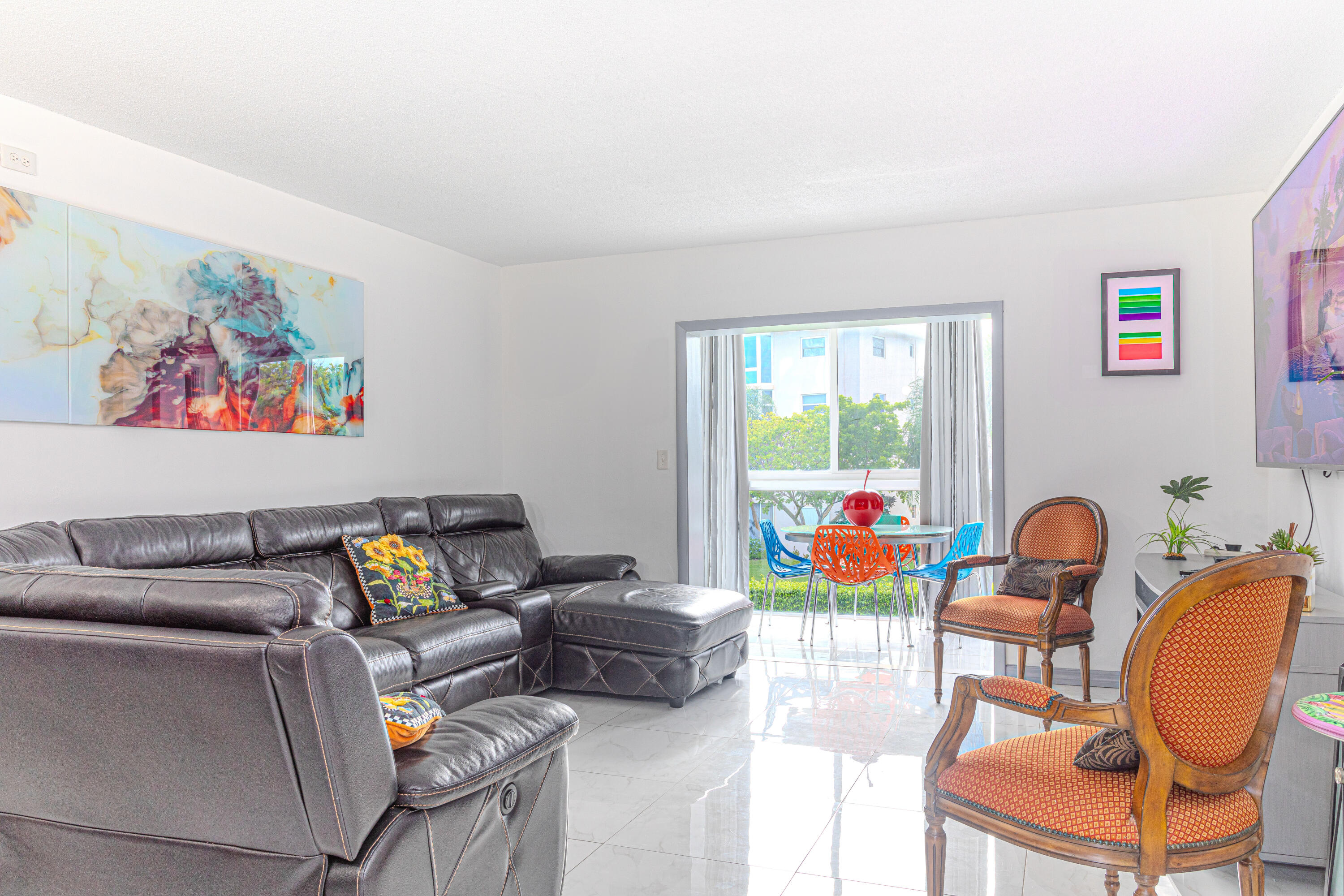 a living room with furniture and a floor to ceiling window