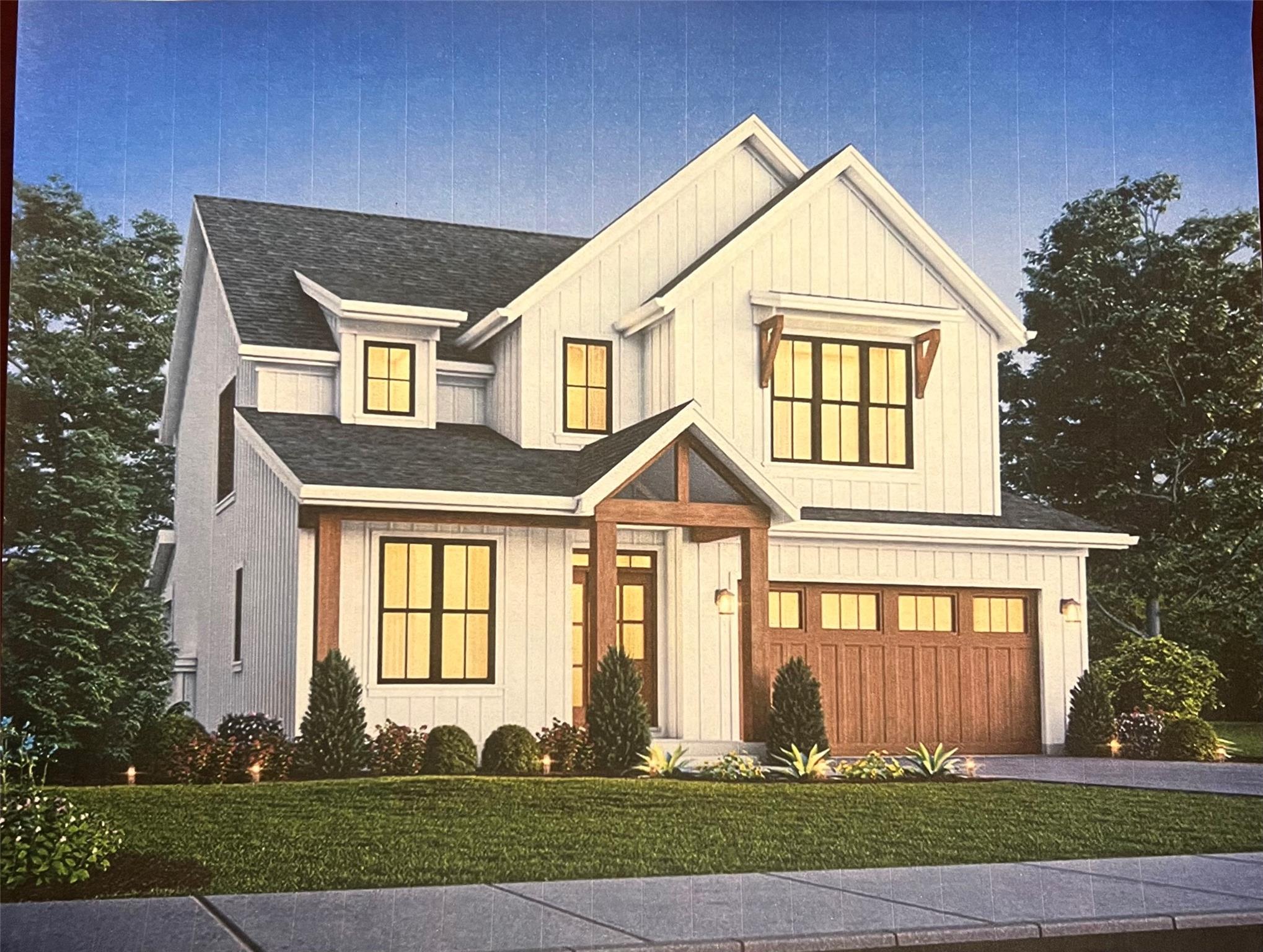 Modern farmhouse with a front lawn and a garage