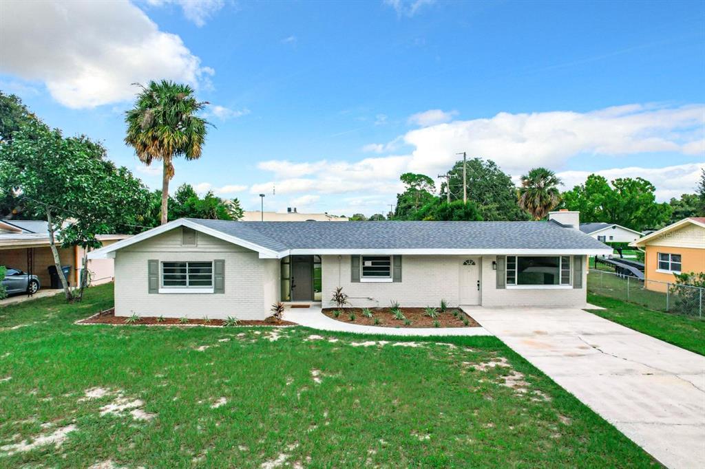 a front view of house with yard and green space