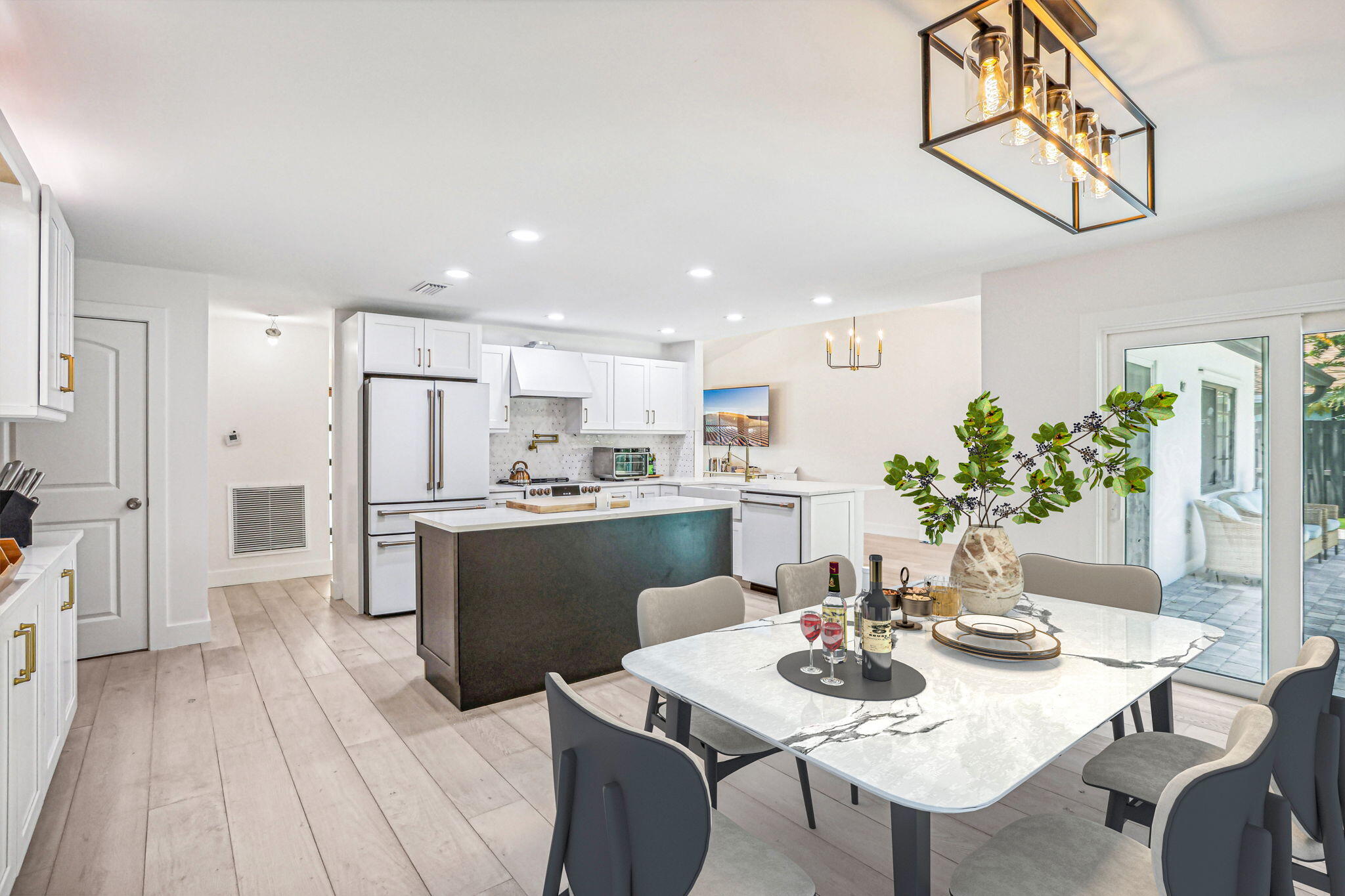 a kitchen with a dining table chairs wooden floor and appliances