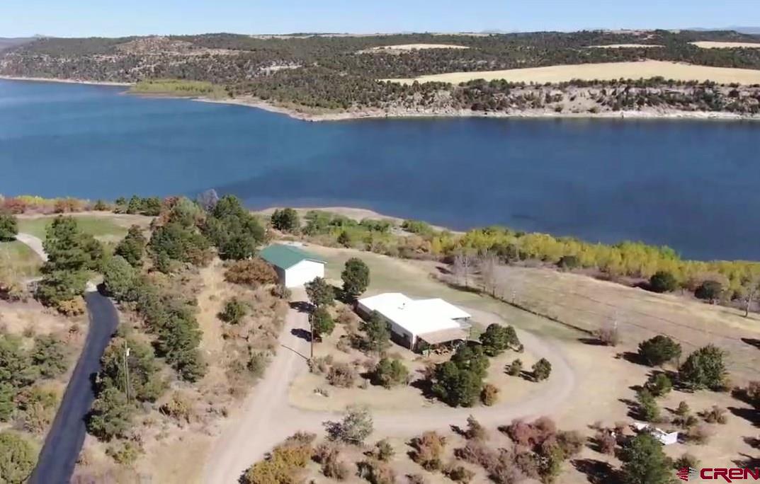 an aerial view of a houses with a lake view