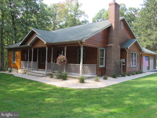 a front view of house with yard outdoor seating and green space