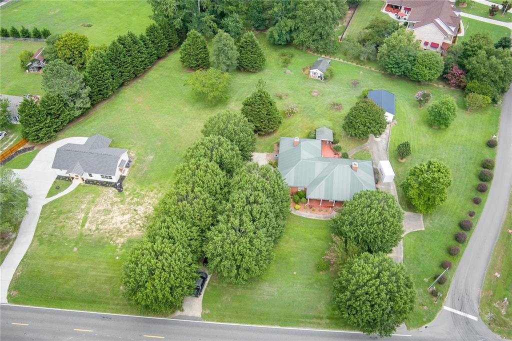 an aerial view of residential houses with outdoor space and street view