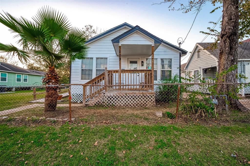 a view of a house with a yard and a porch