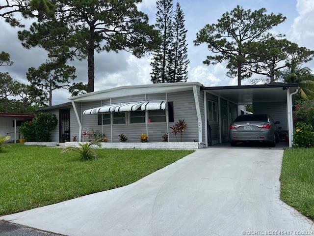 a view of a car parked in front of house with a yard