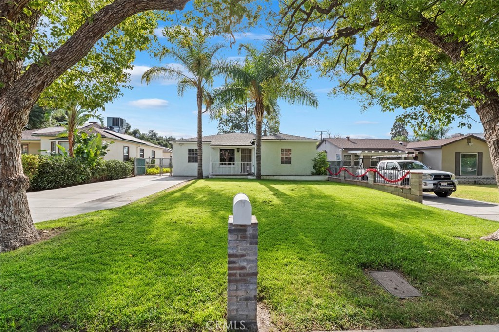 a front view of house with yard and green space