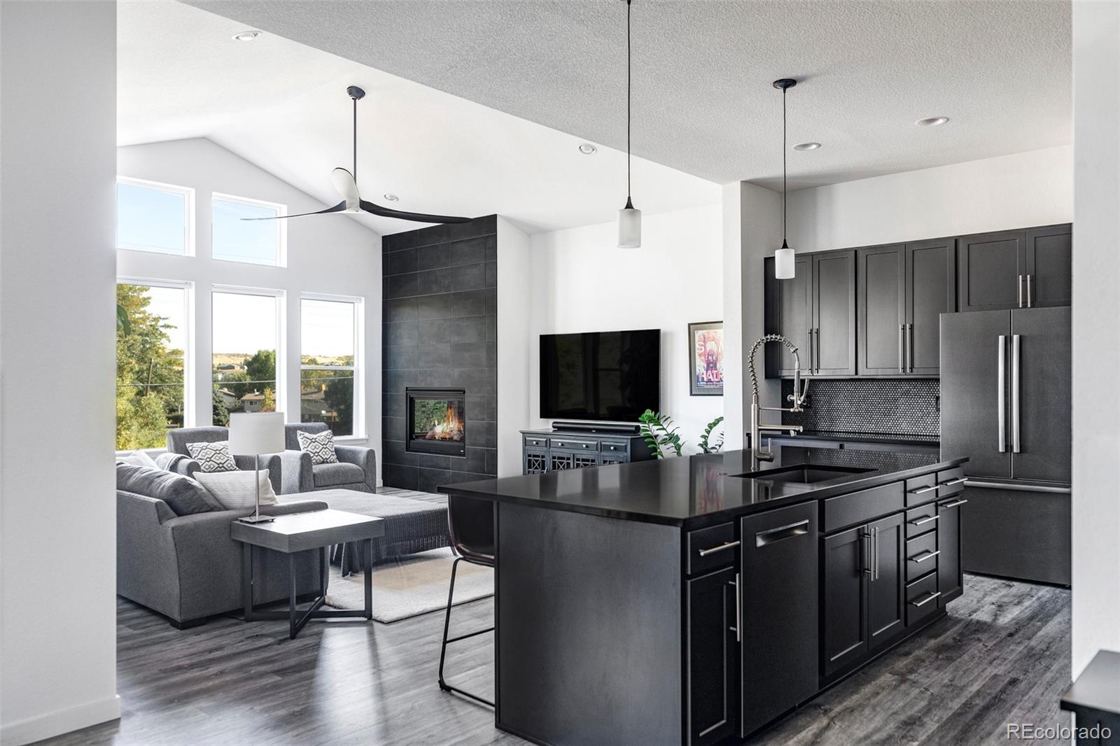 a kitchen with kitchen island a counter space a sink appliances and a window