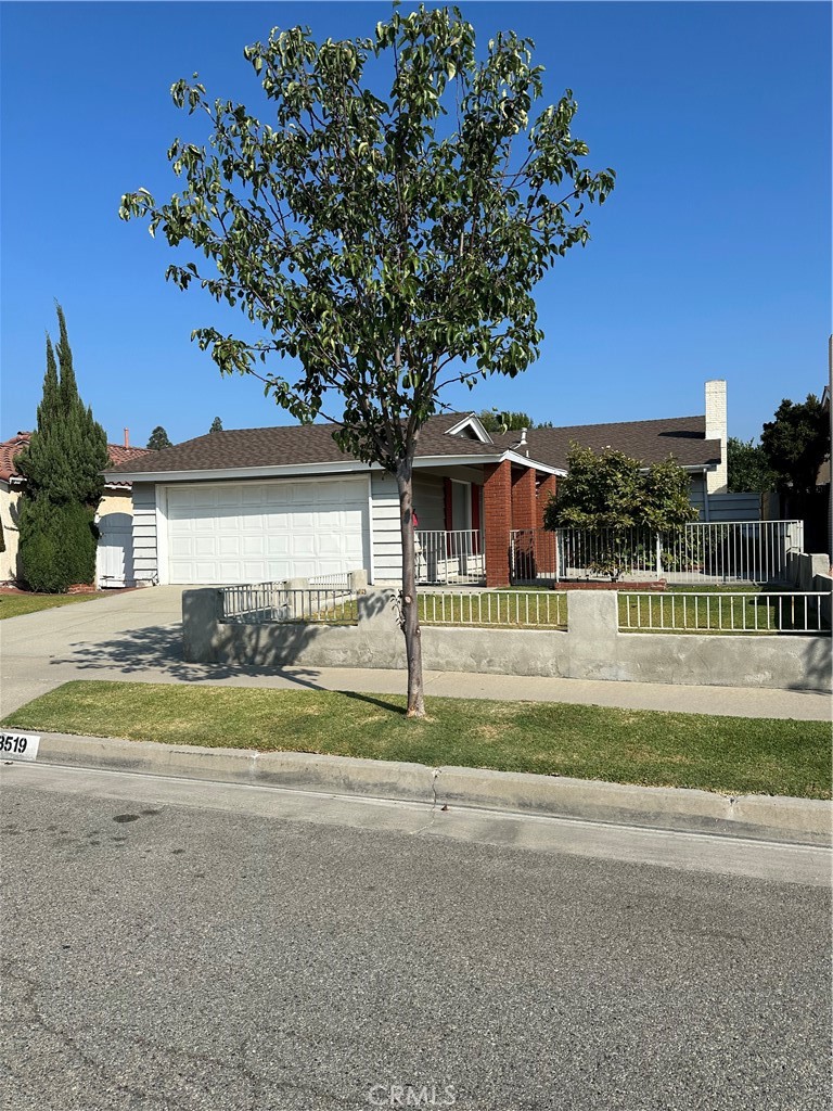 a front view of a house with a garden and yard