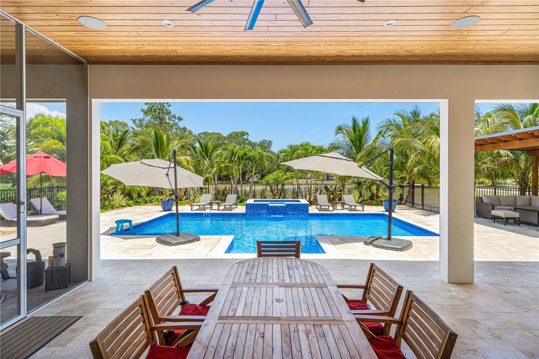 a view of swimming pool with a lounge chairs