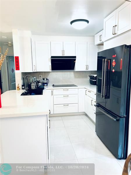 a kitchen with stainless steel appliances a refrigerator sink and cabinets