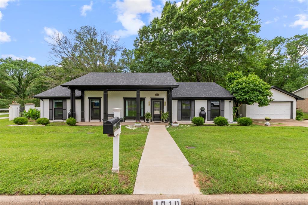 a front view of a house with yard patio and green space