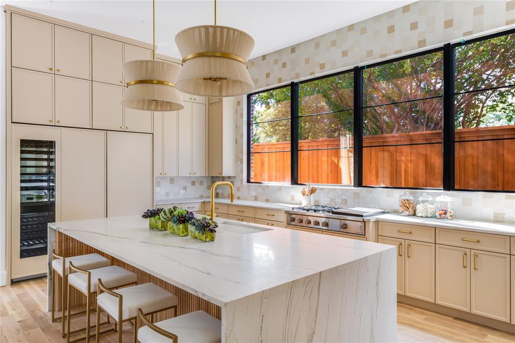 a kitchen with stainless steel appliances a sink a counter top space and living room view