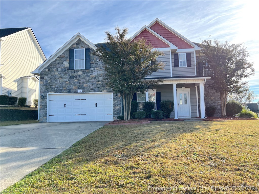 a front view of a house with a yard and garage