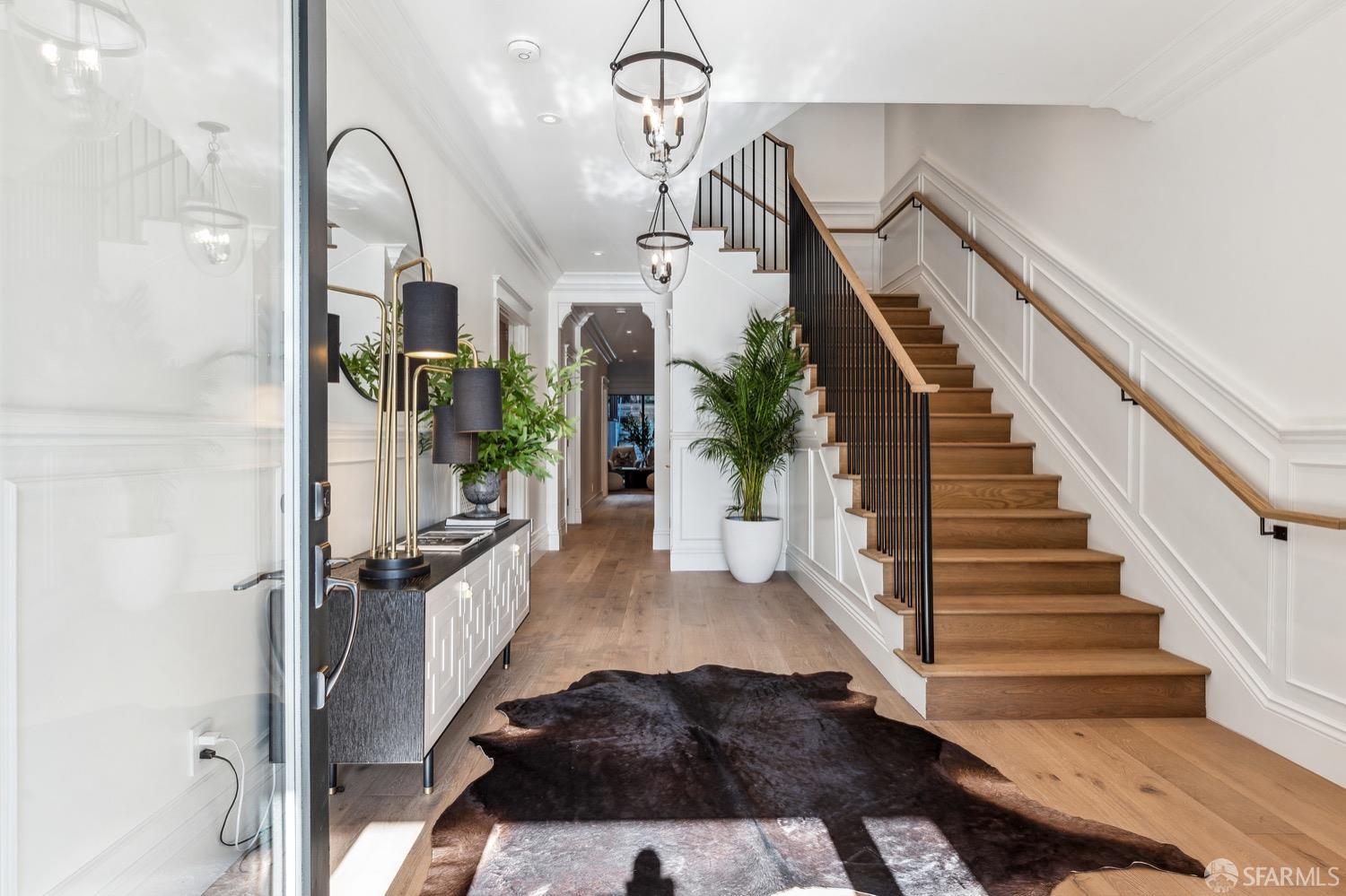 a view of entryway and hall with wooden floor