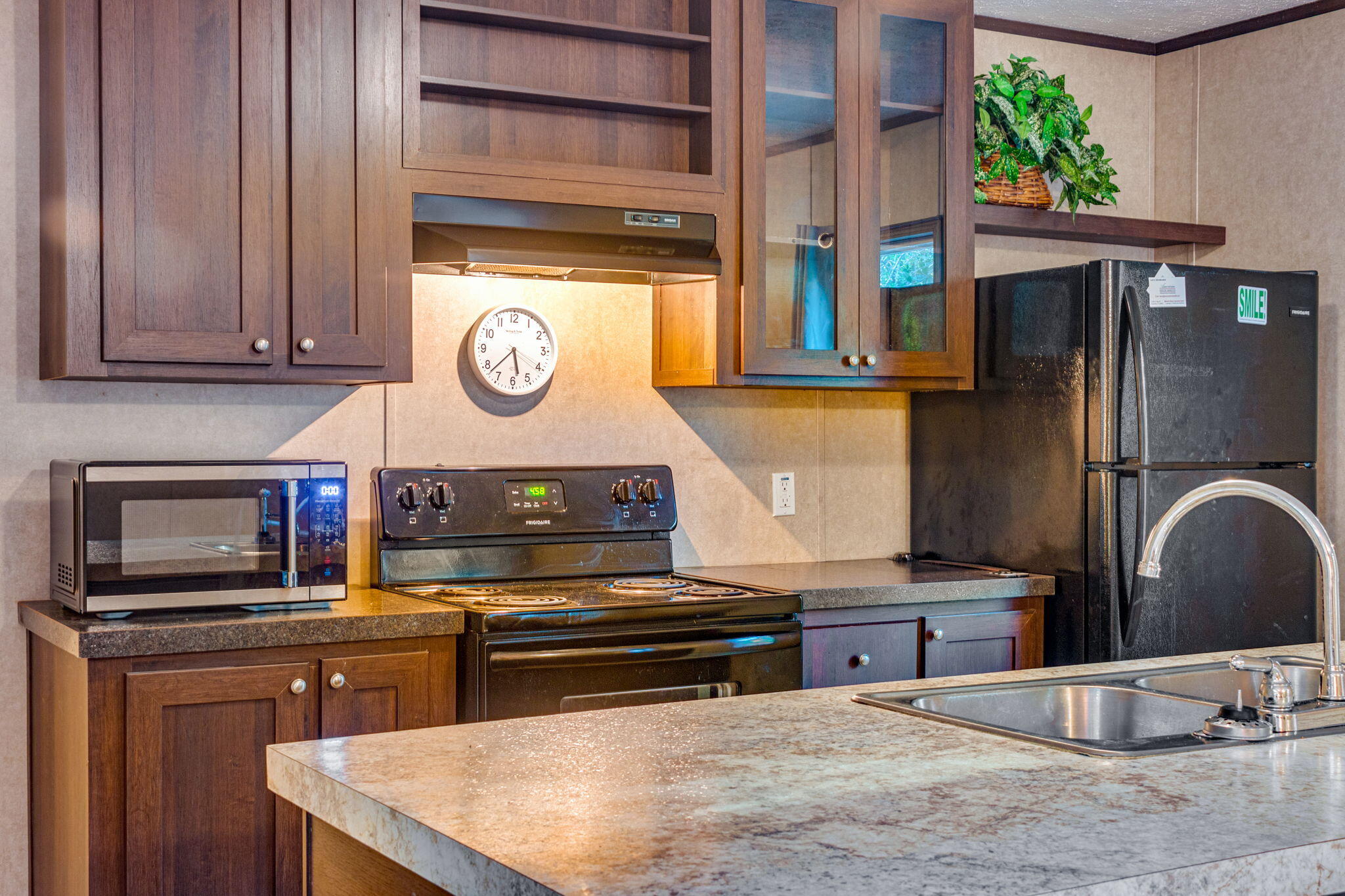 a kitchen with stainless steel appliances granite countertop a stove a sink and a microwave