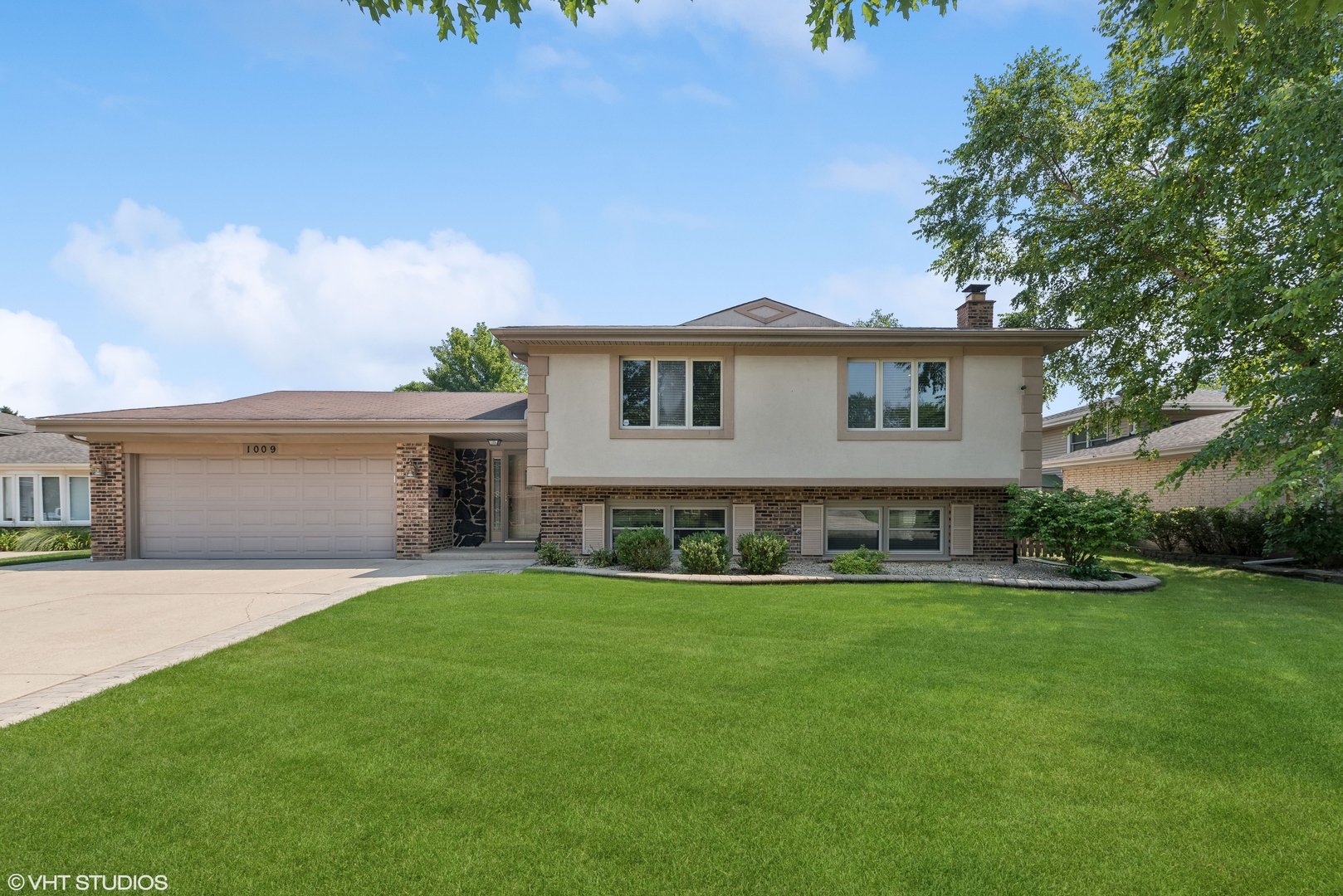 a front view of house with yard and green space