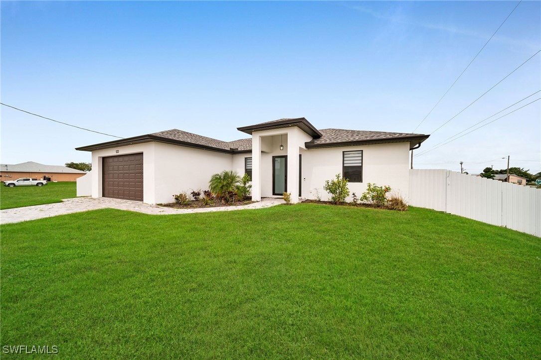 a view of a yard in front of a house with green space