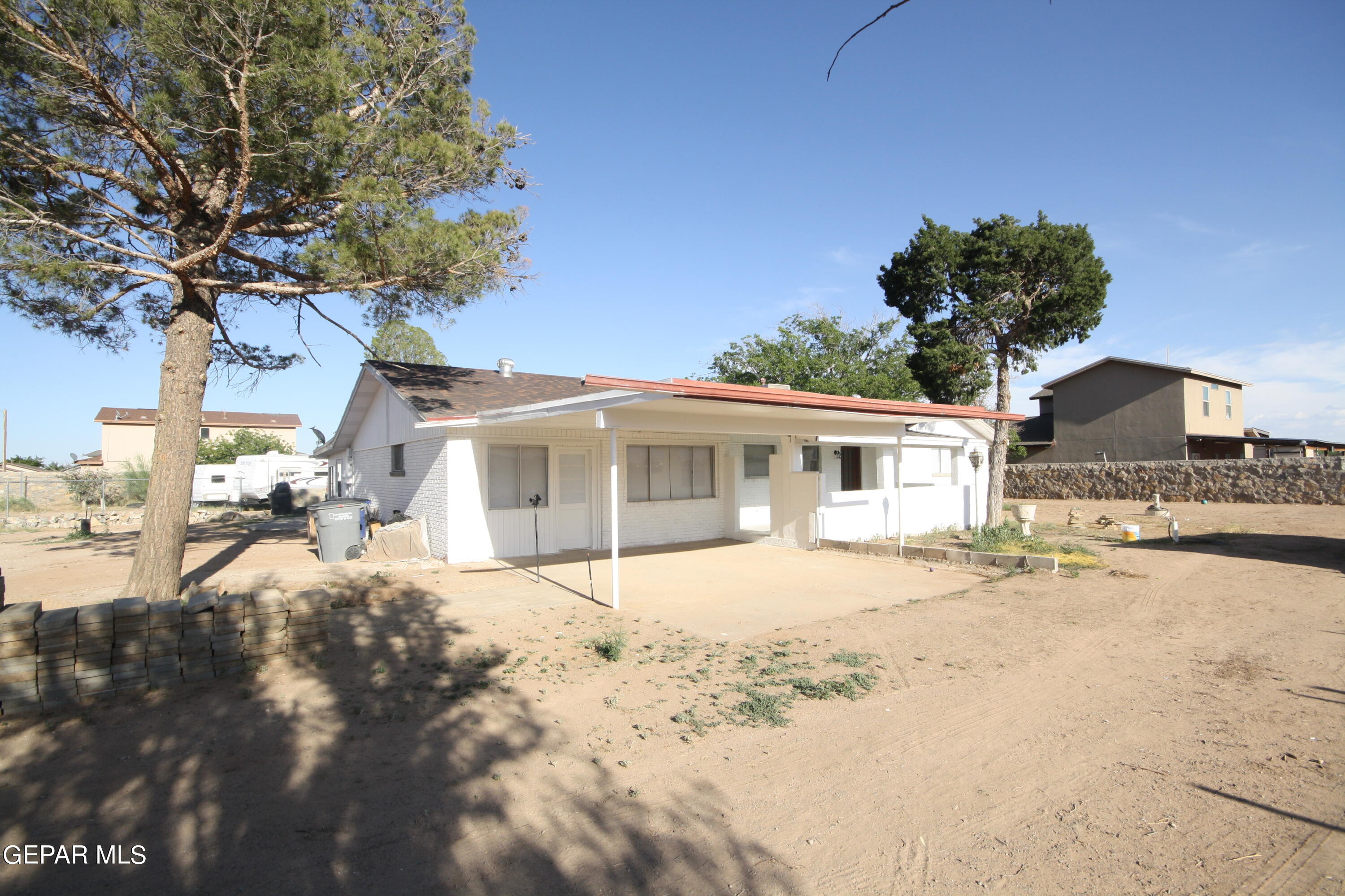 a front view of a house with a yard covered with snow in front of house