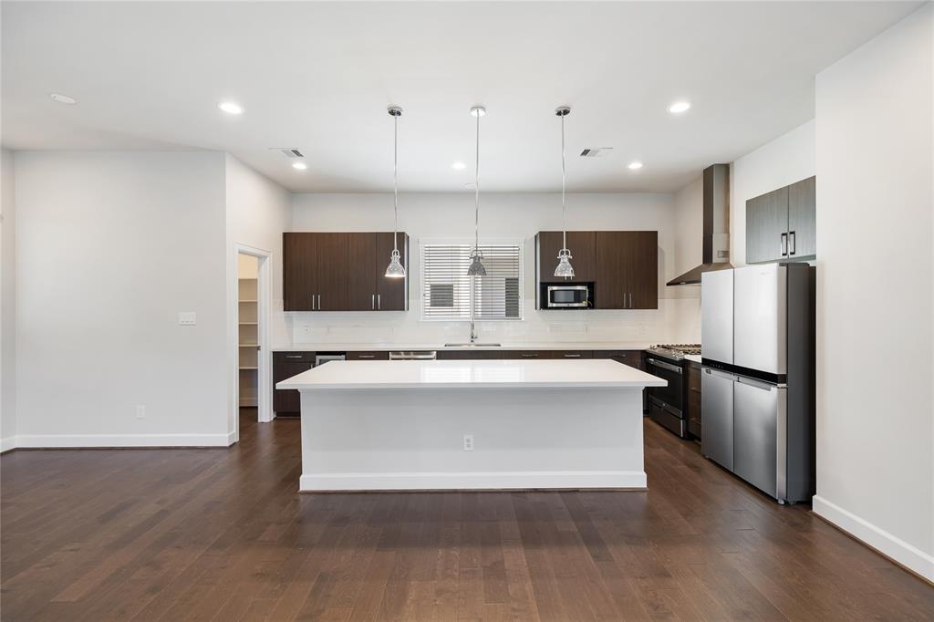 a view of kitchen with stainless steel appliances a refrigerator and a microwave