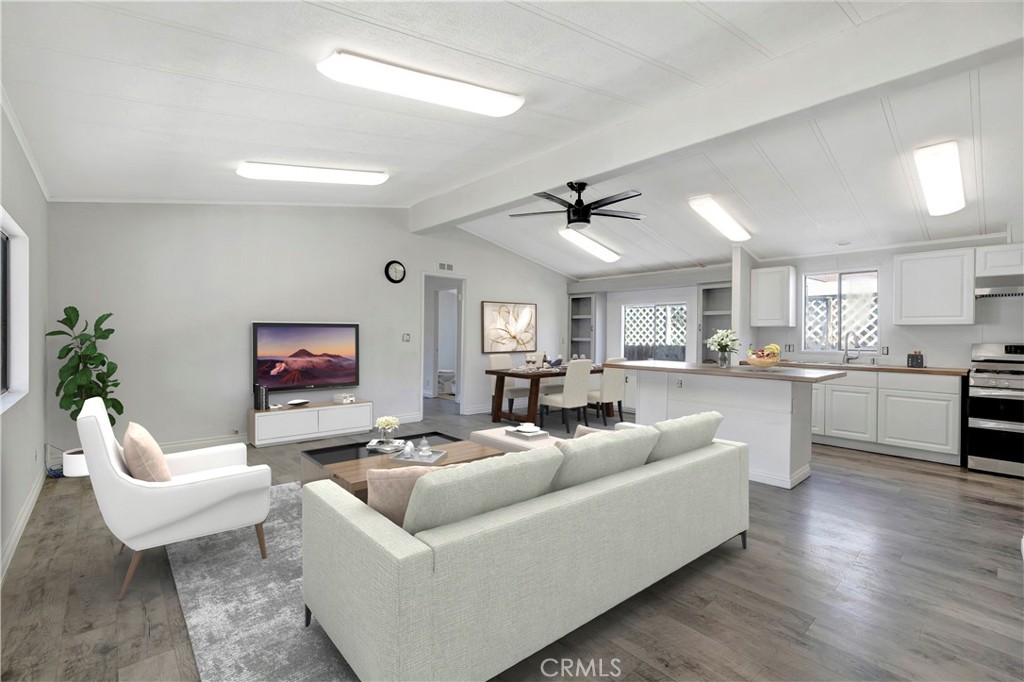 a living room with furniture kitchen view and a fireplace