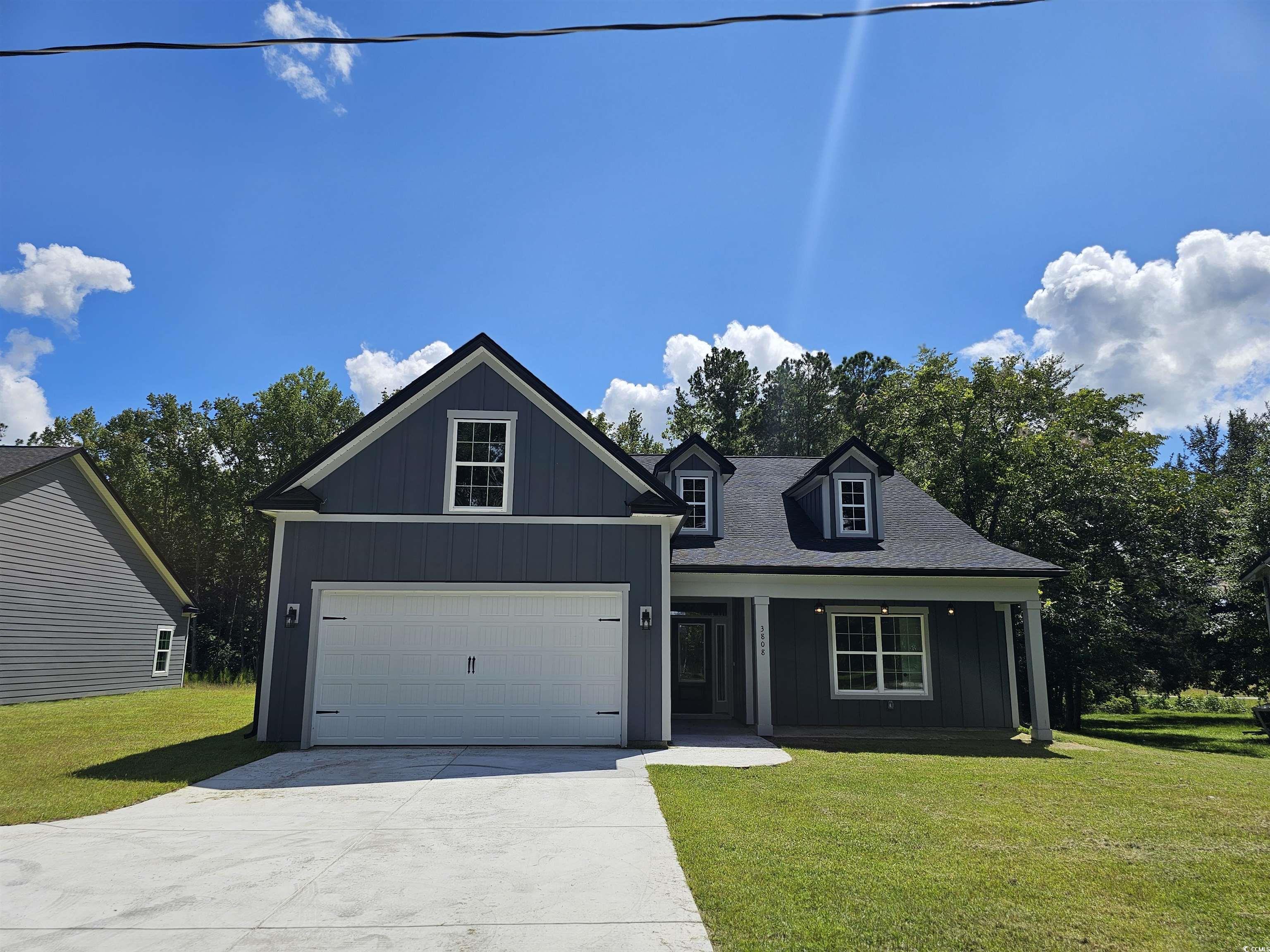 View of front of property featuring a garage, cove