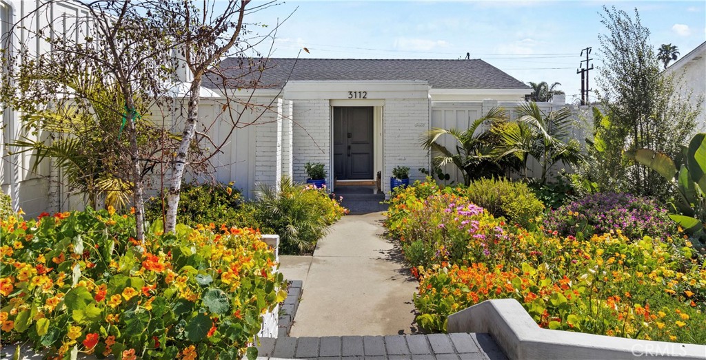 a front view of a house with a yard and fountain