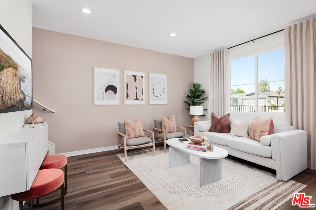 a living room with furniture and a wooden floor