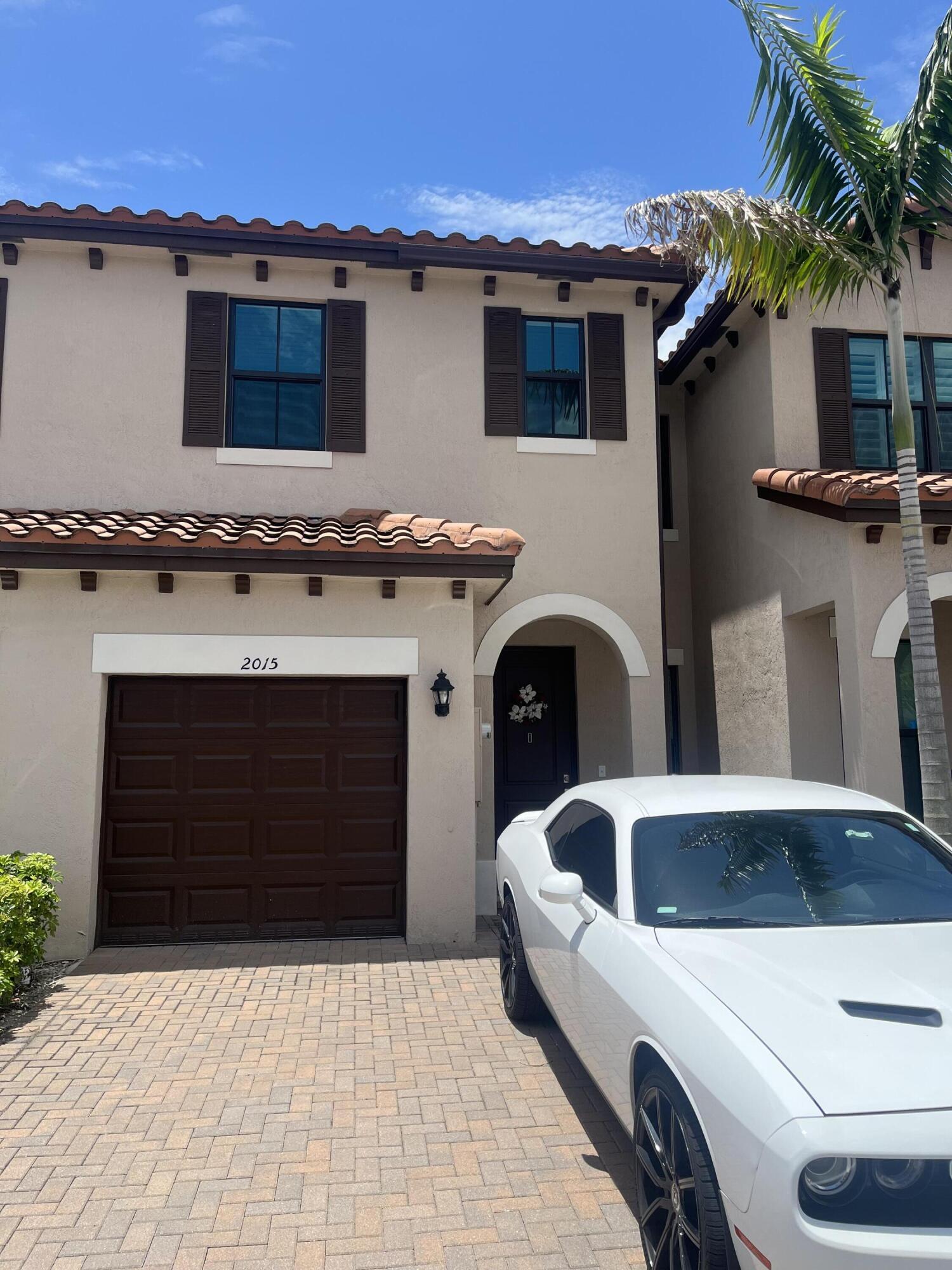 a front view of a house with parking space