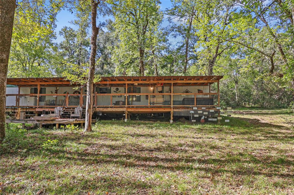 a backyard of a house with wooden fence and floor