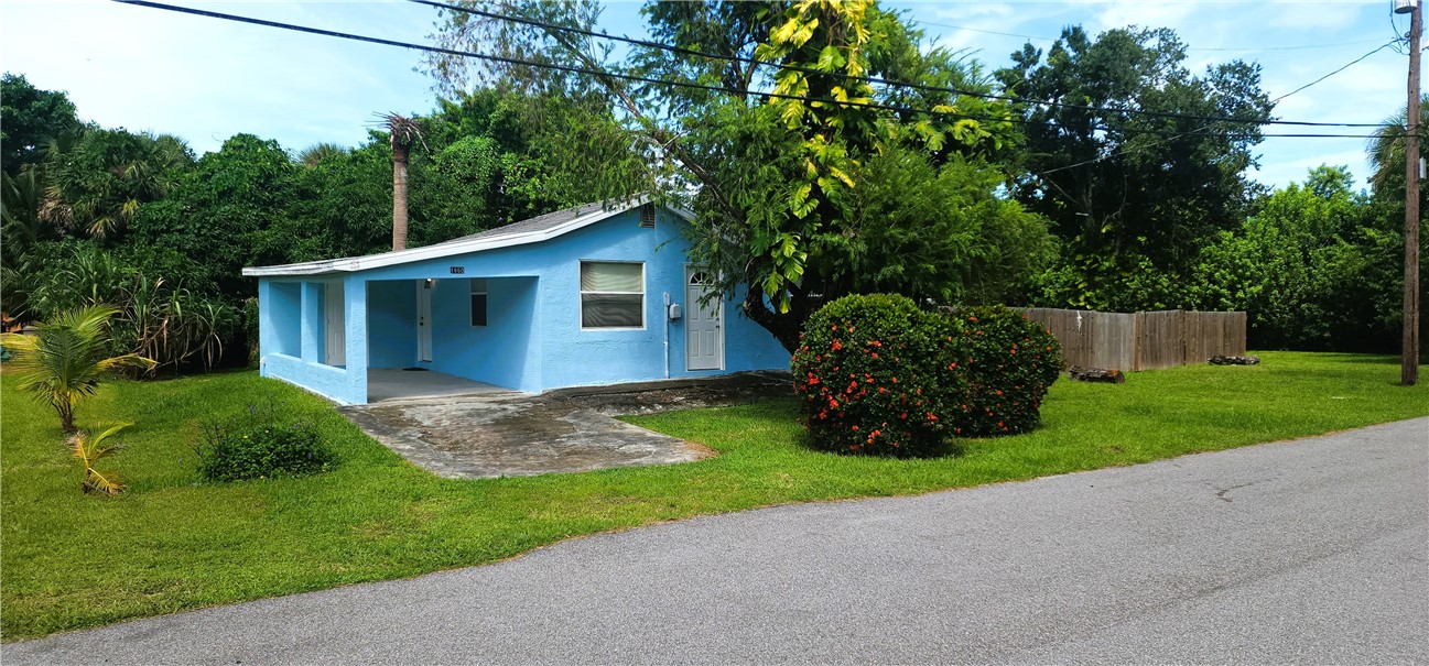 a view of a house with a yard and plants