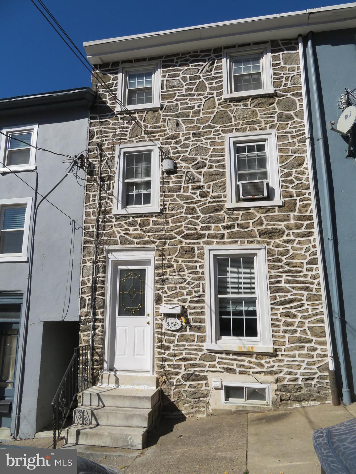 a front view of a house with stairs