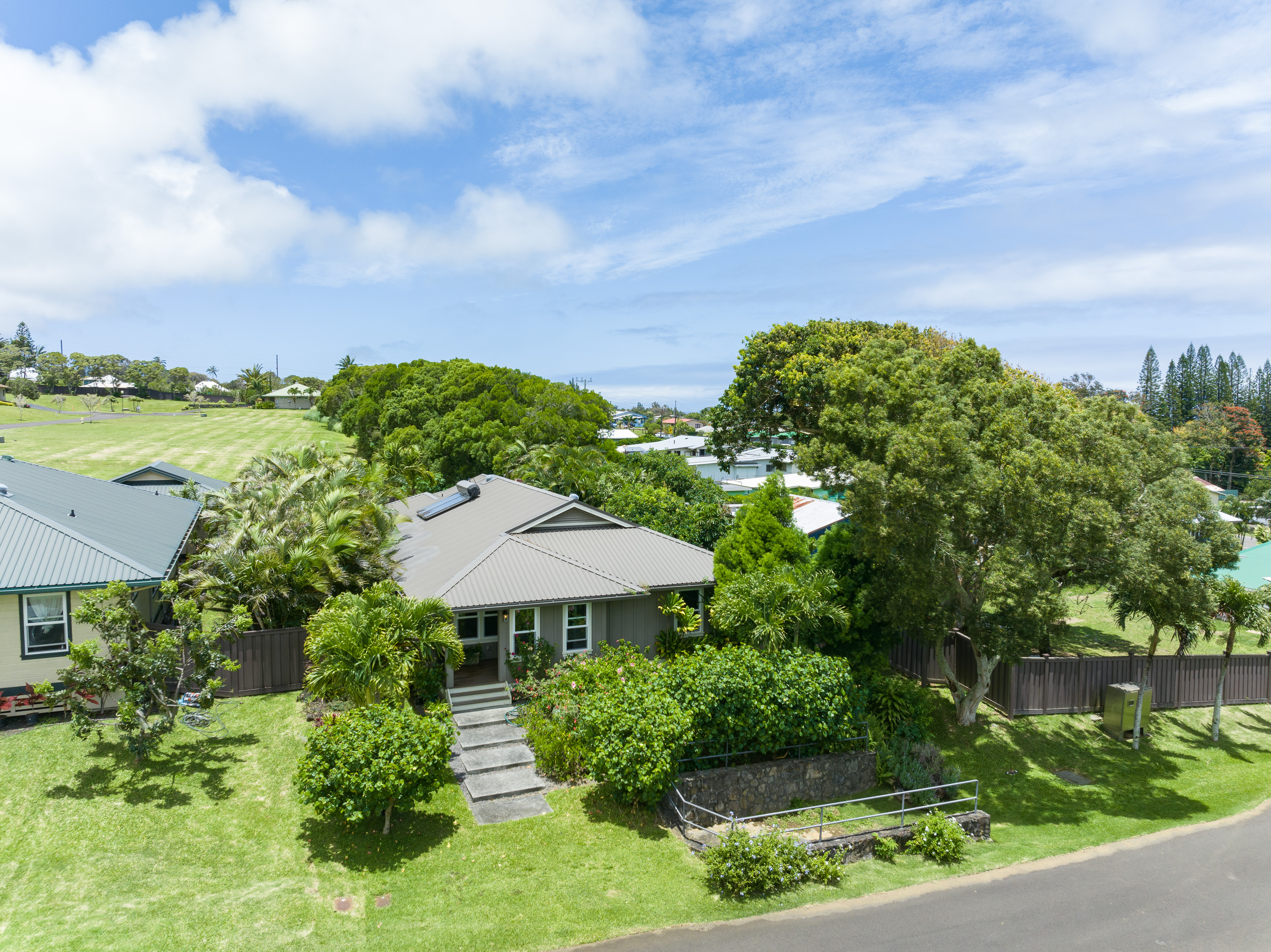 an aerial view of a house with garden space and street view