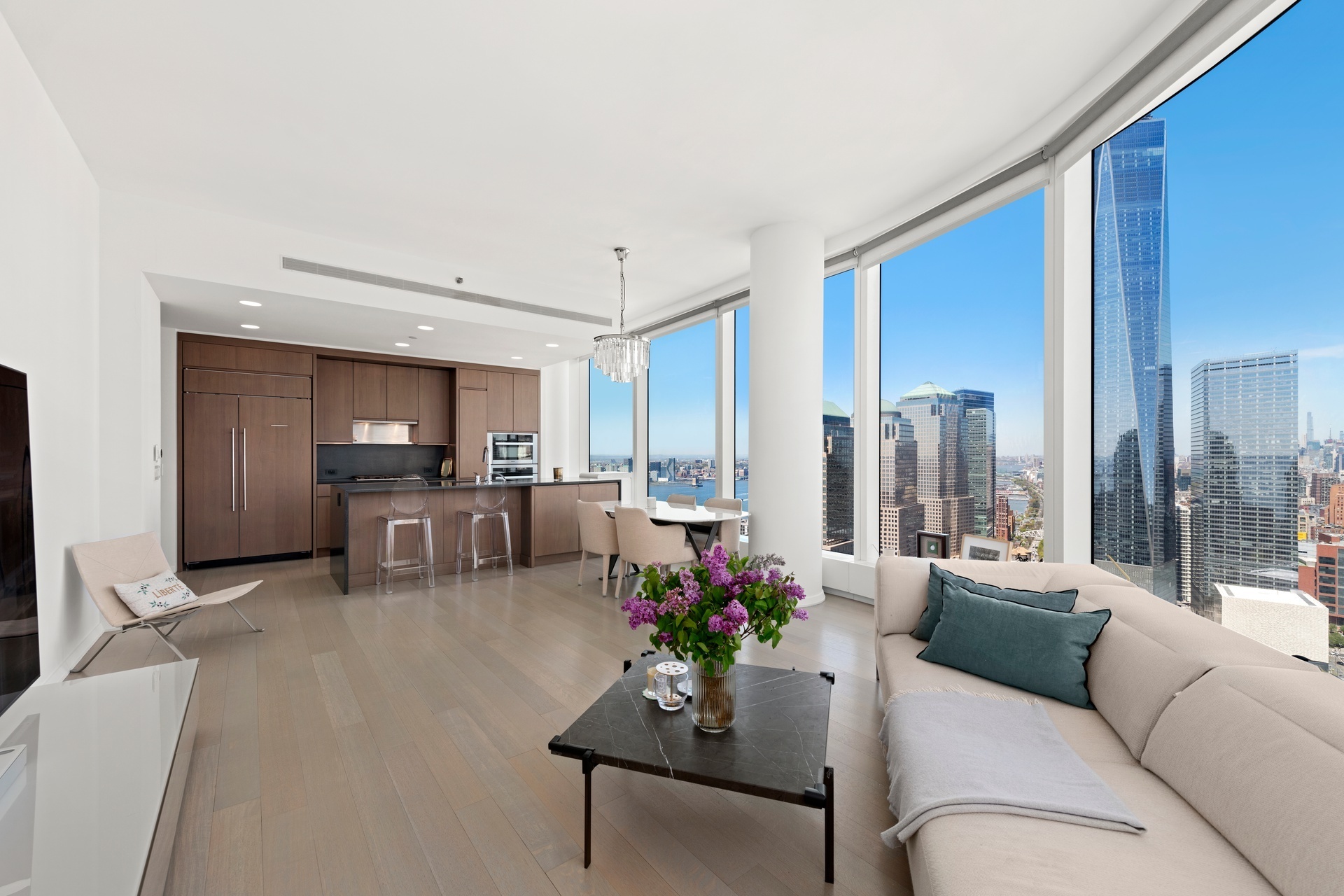 a living room with furniture kitchen and a large window