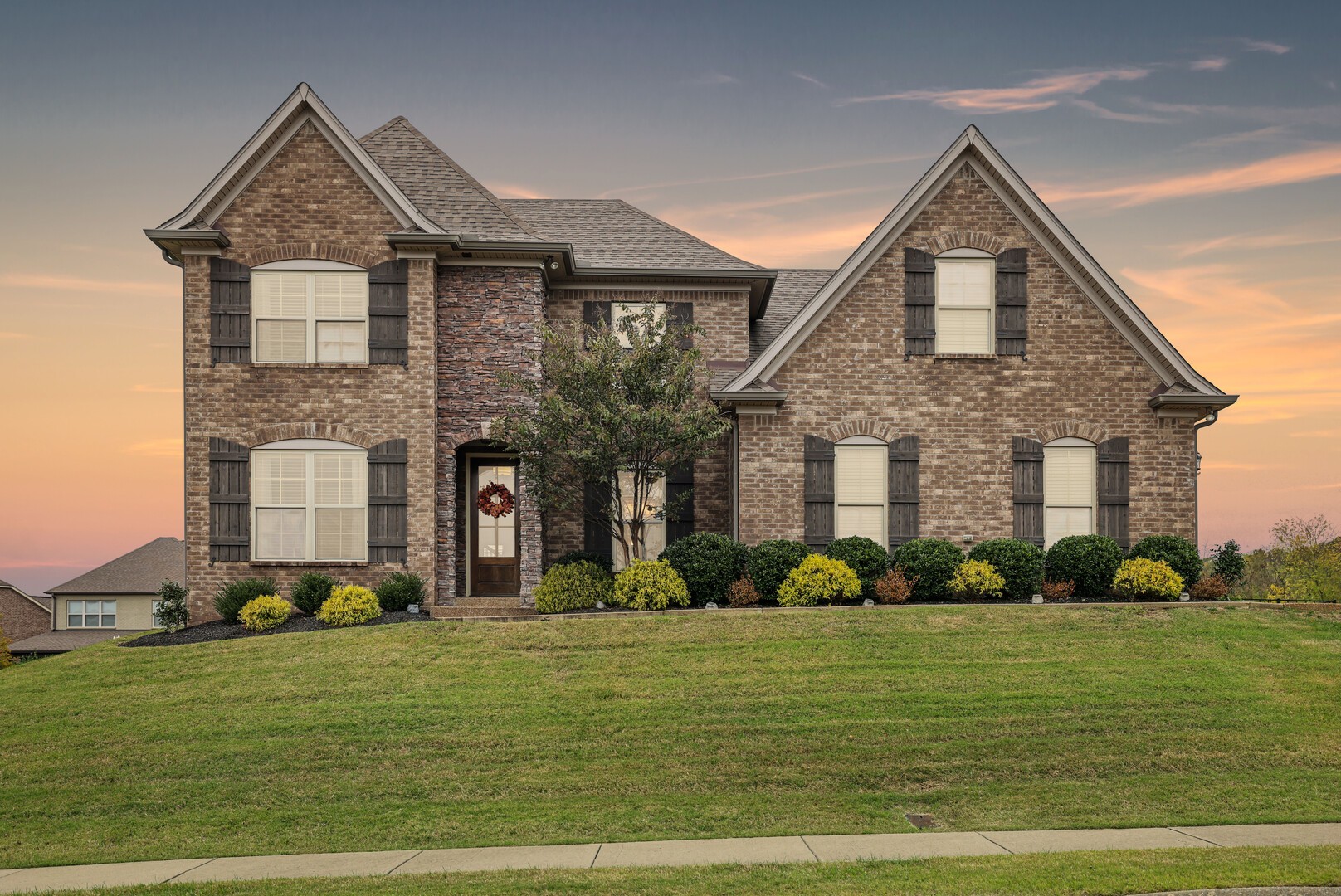 a front view of a house with a yard