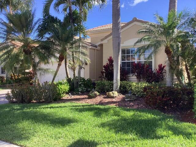 a view of a house with a yard and potted plants