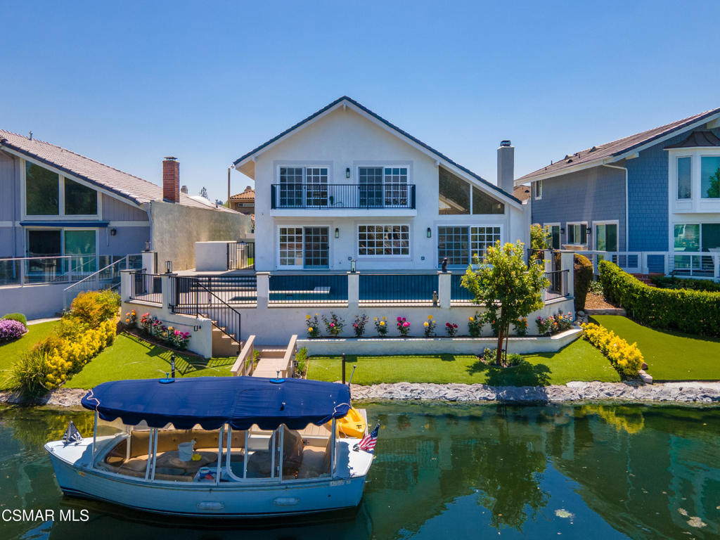 a view of a house with swimming pool and yard