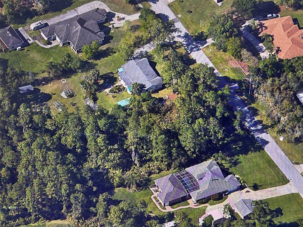 an aerial view of house with swimming pool