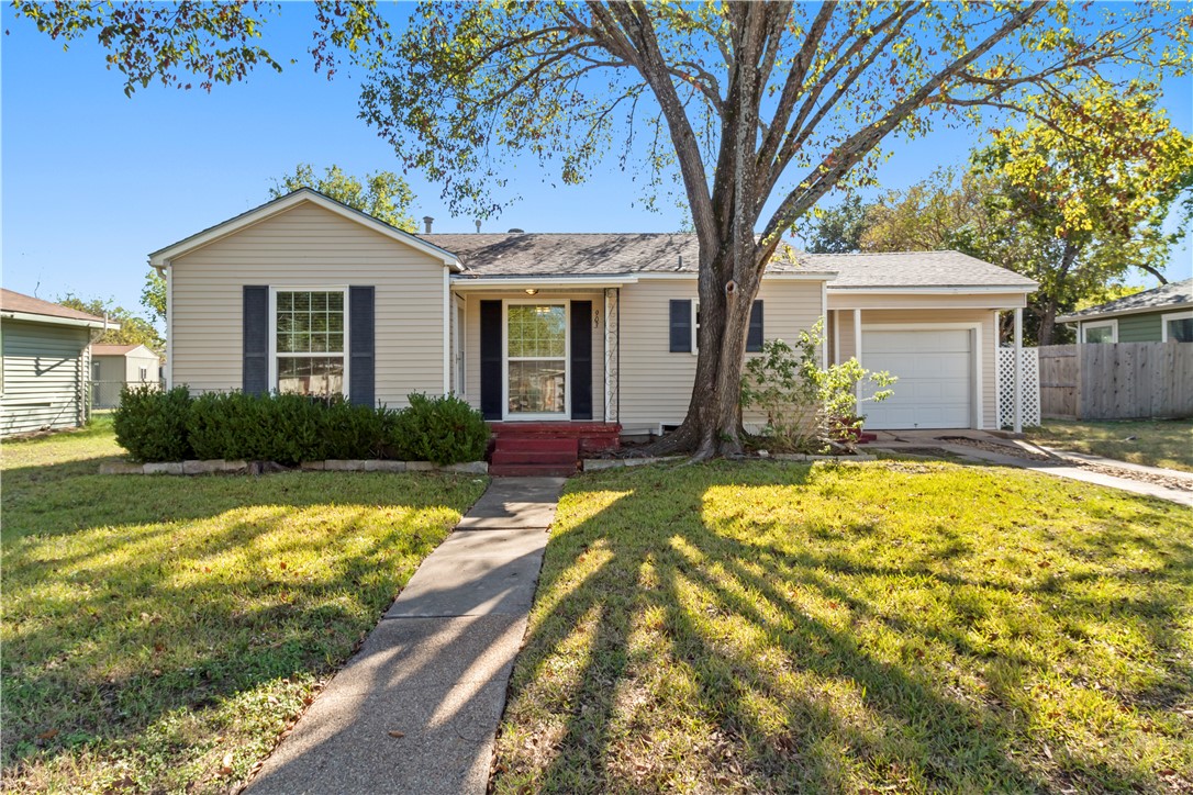 Ranch-style house with a front lawn and a garage