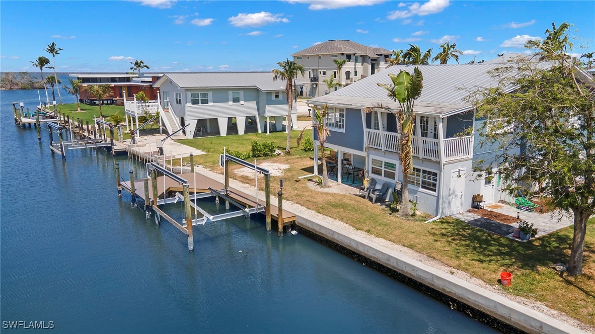 an aerial view of a house with swimming pool and furniture