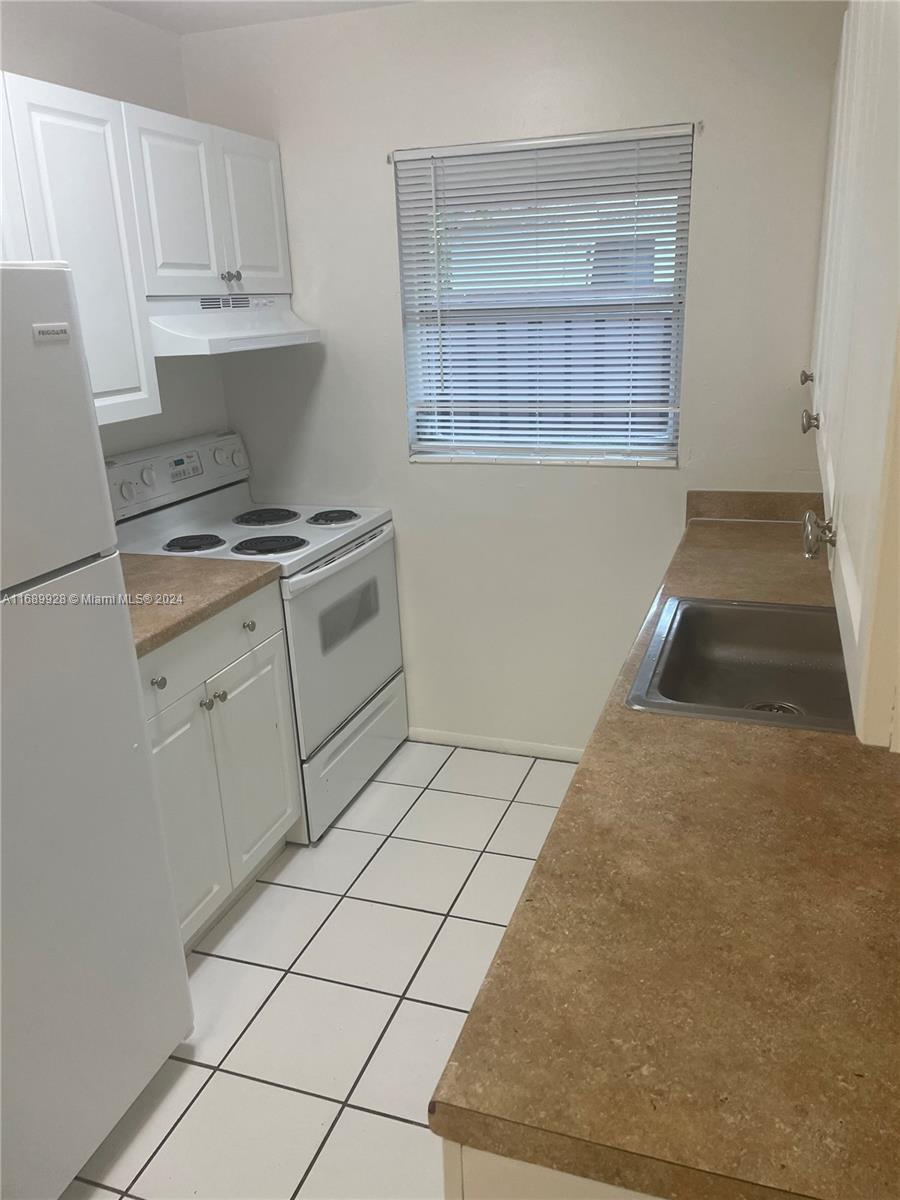 a kitchen with a stove and a refrigerator