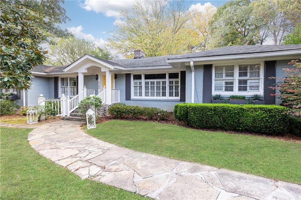 a front view of a house with a yard and porch