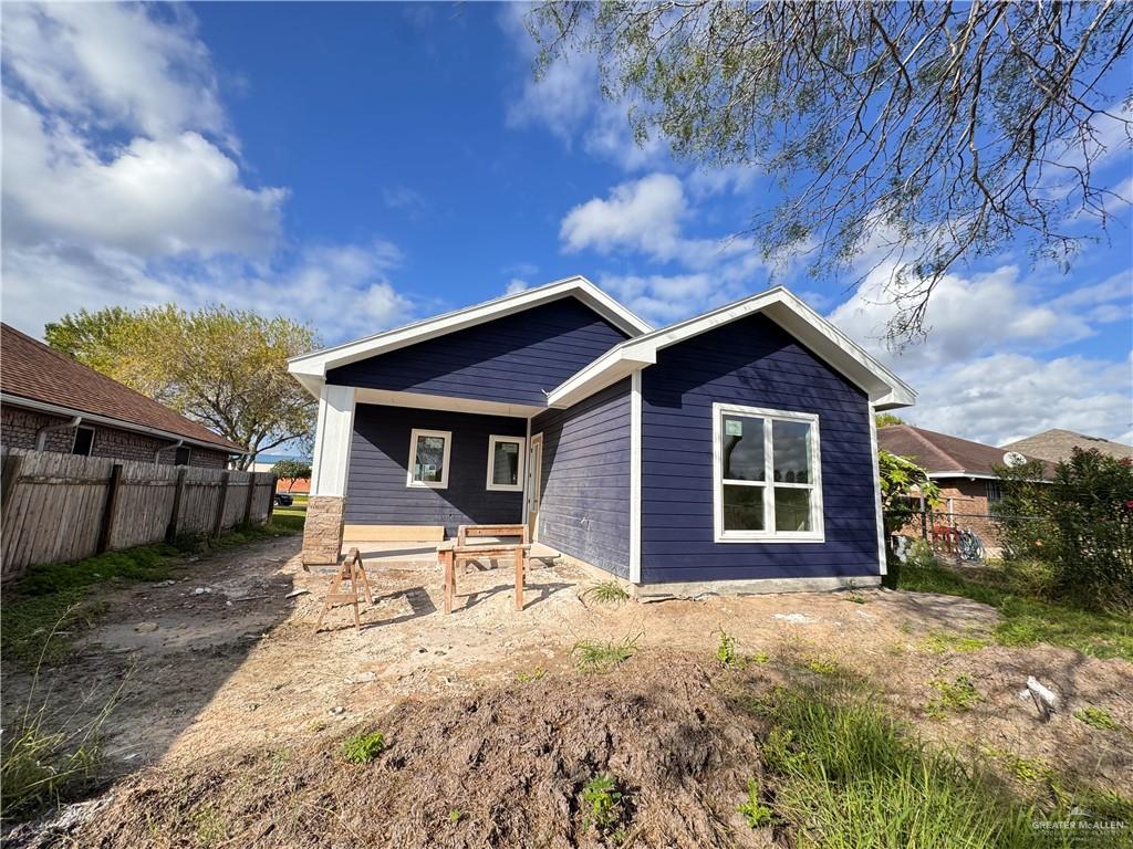 a front view of a house with yard and seating space