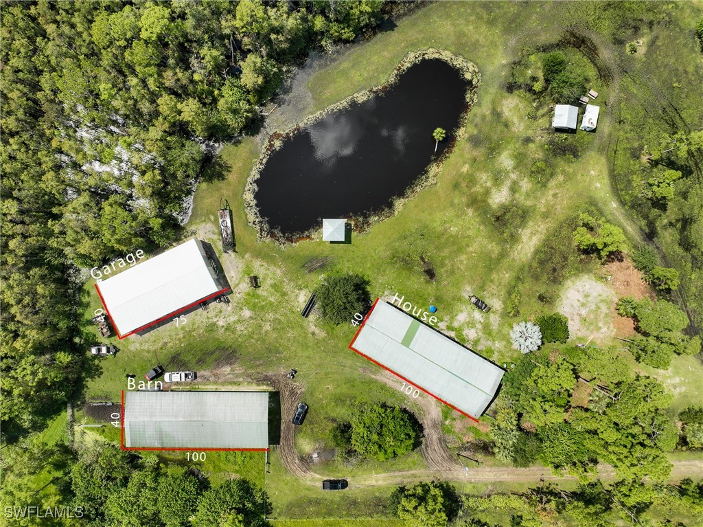 an aerial view of a house with yard