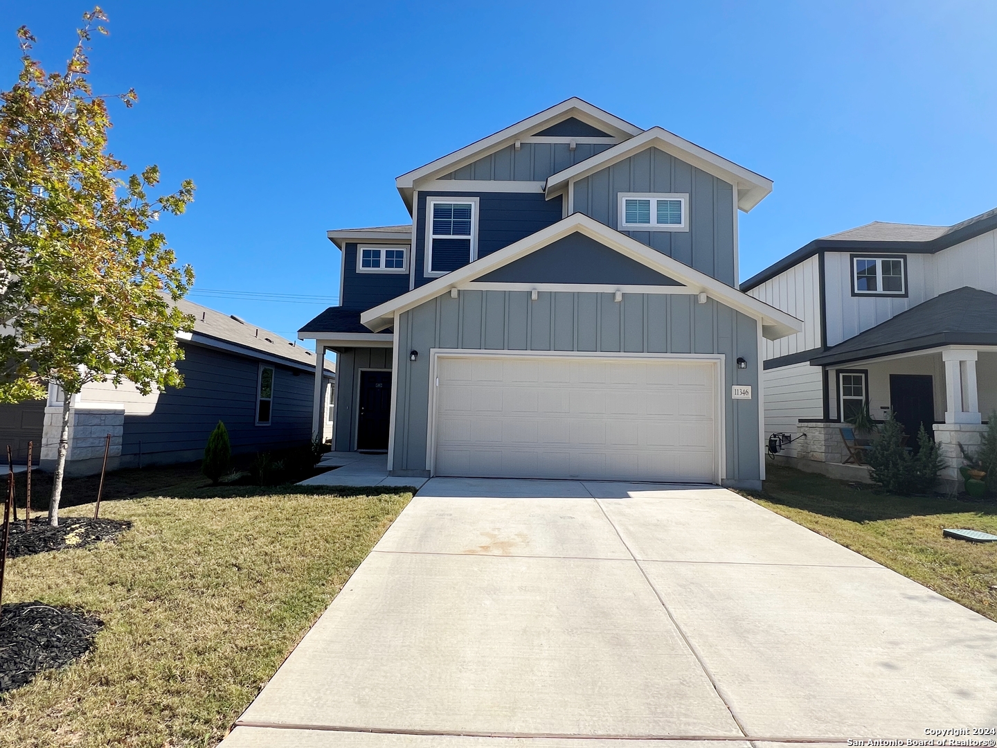 a front view of a house with a yard and garage