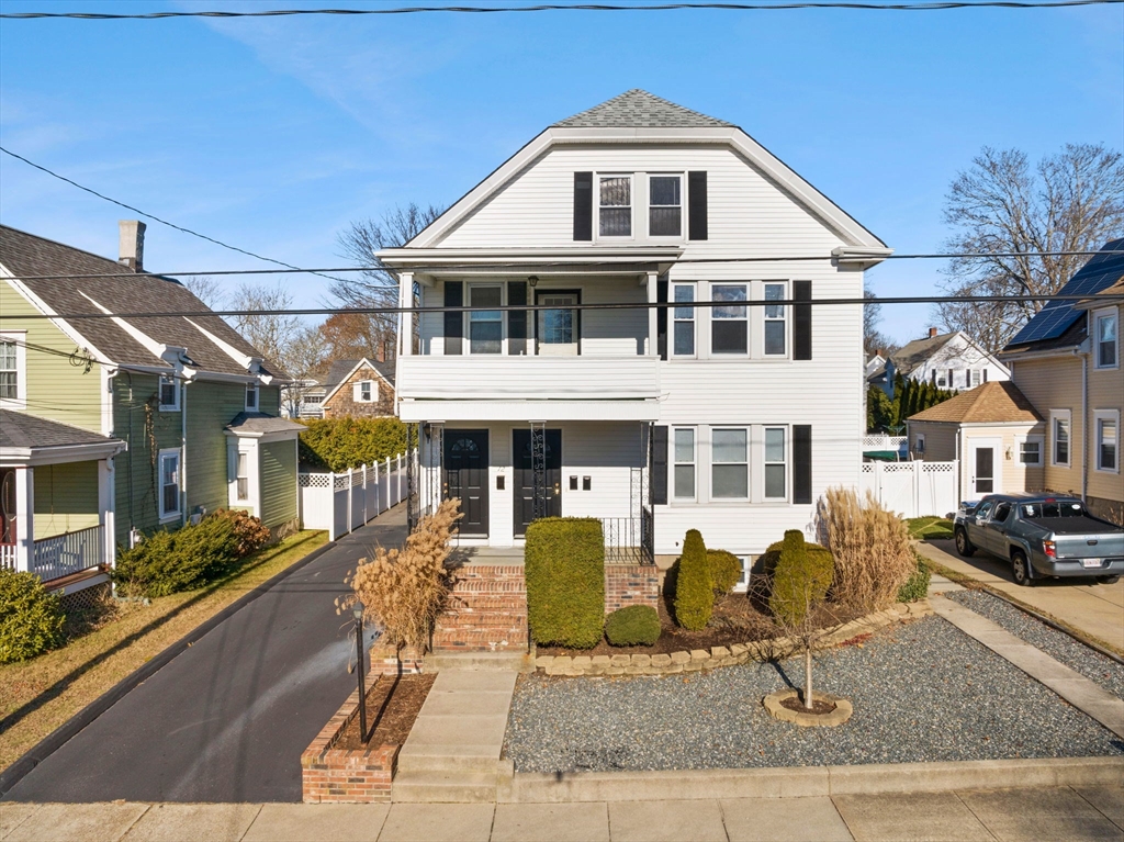 a front view of a house with lots of windows