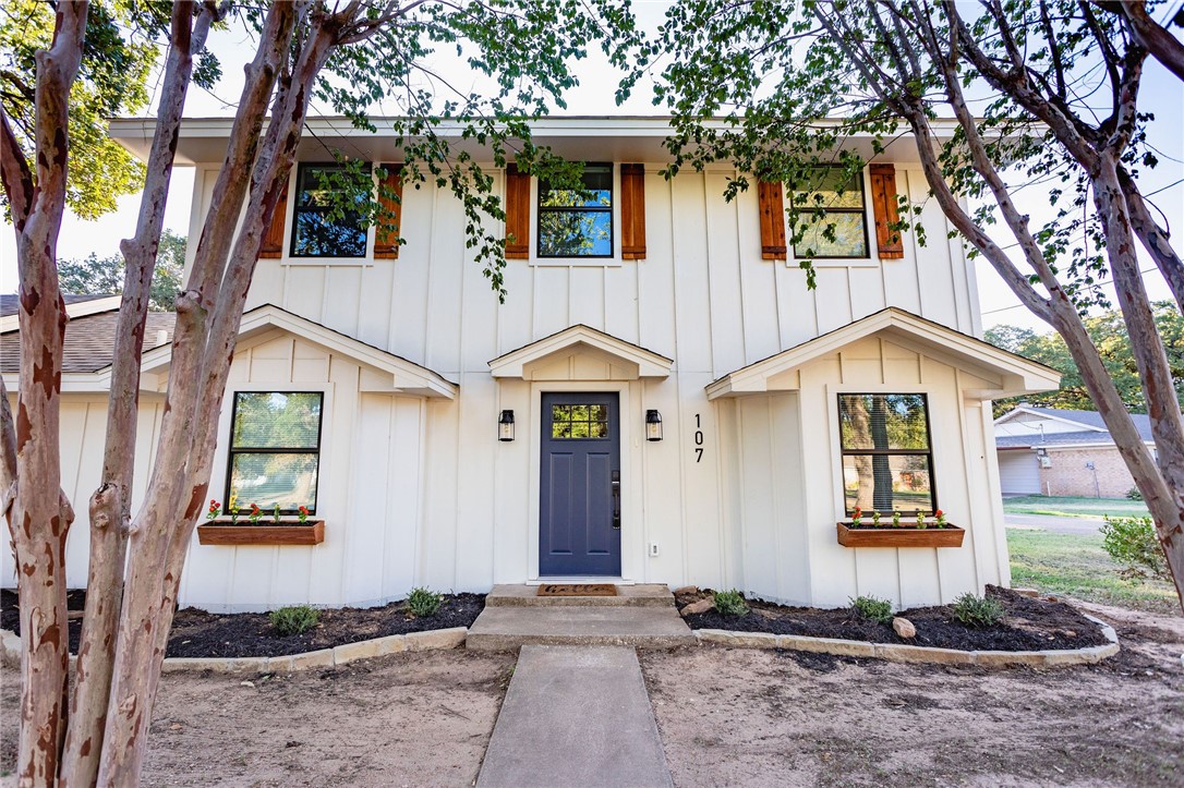 a front view of a house with garden