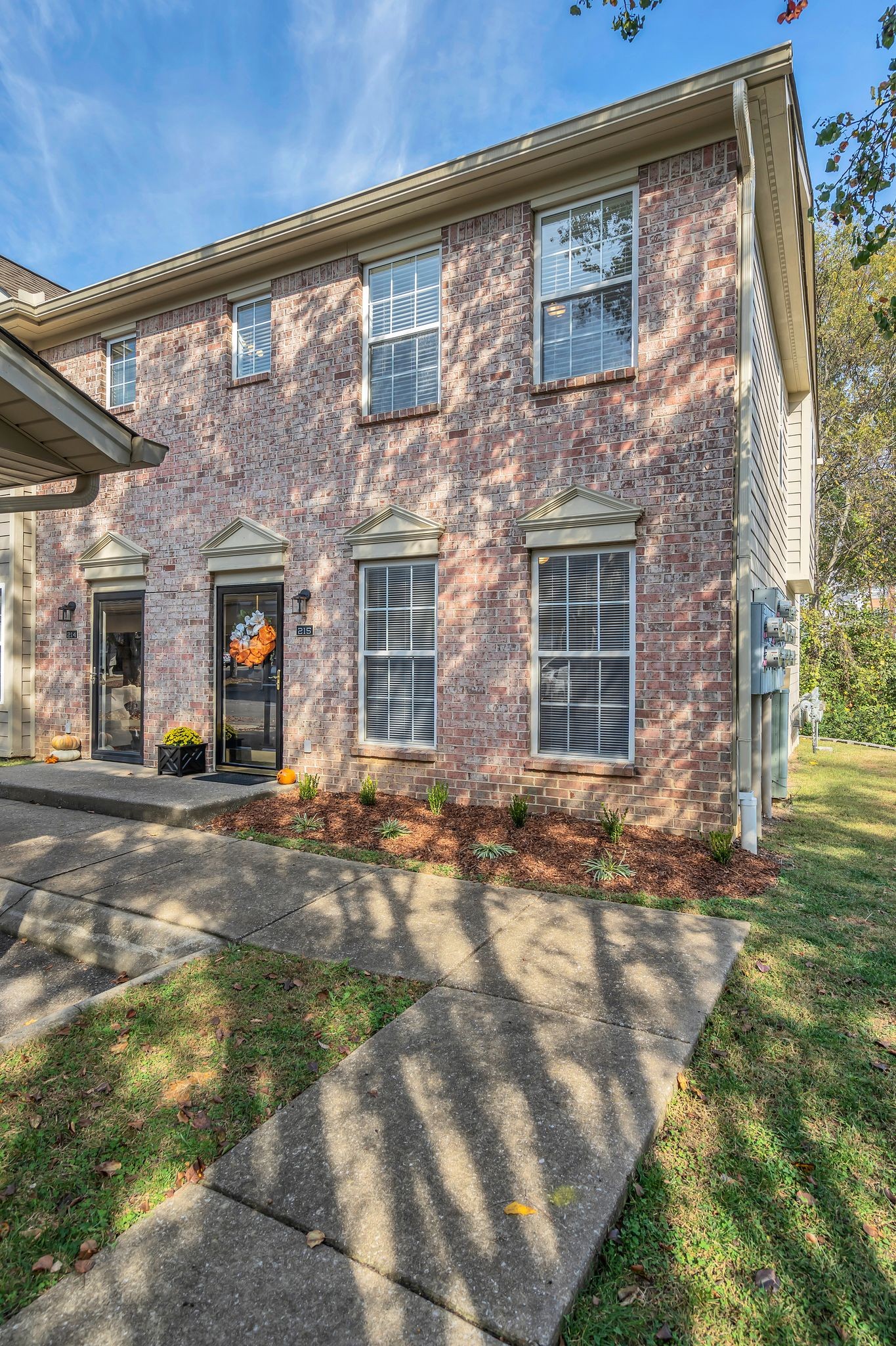 a view of a brick house with many windows