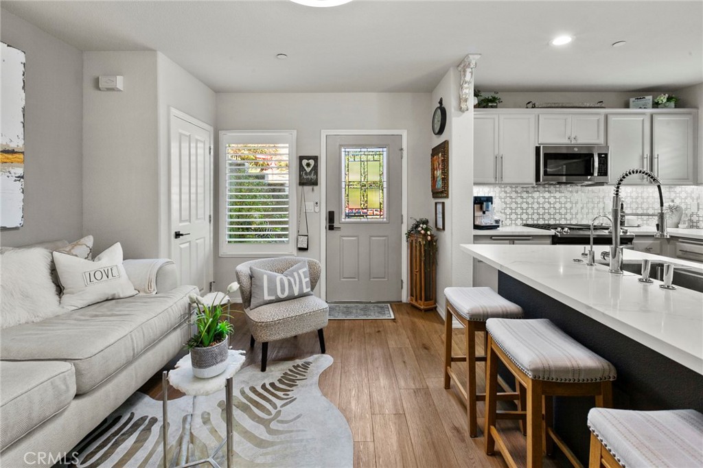 a living room with kitchen island furniture and a wooden floor