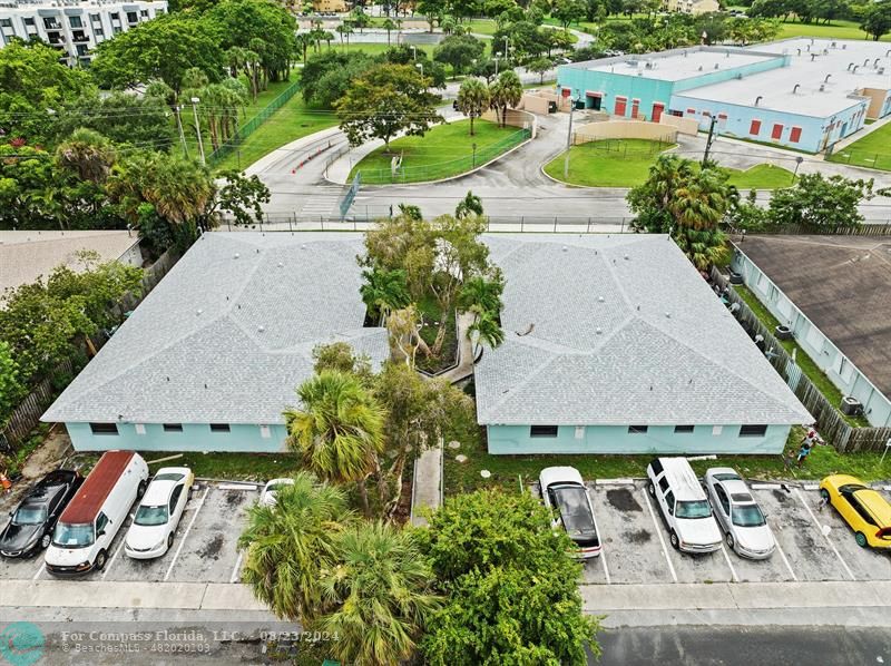 an aerial view of a house with garden space and street view